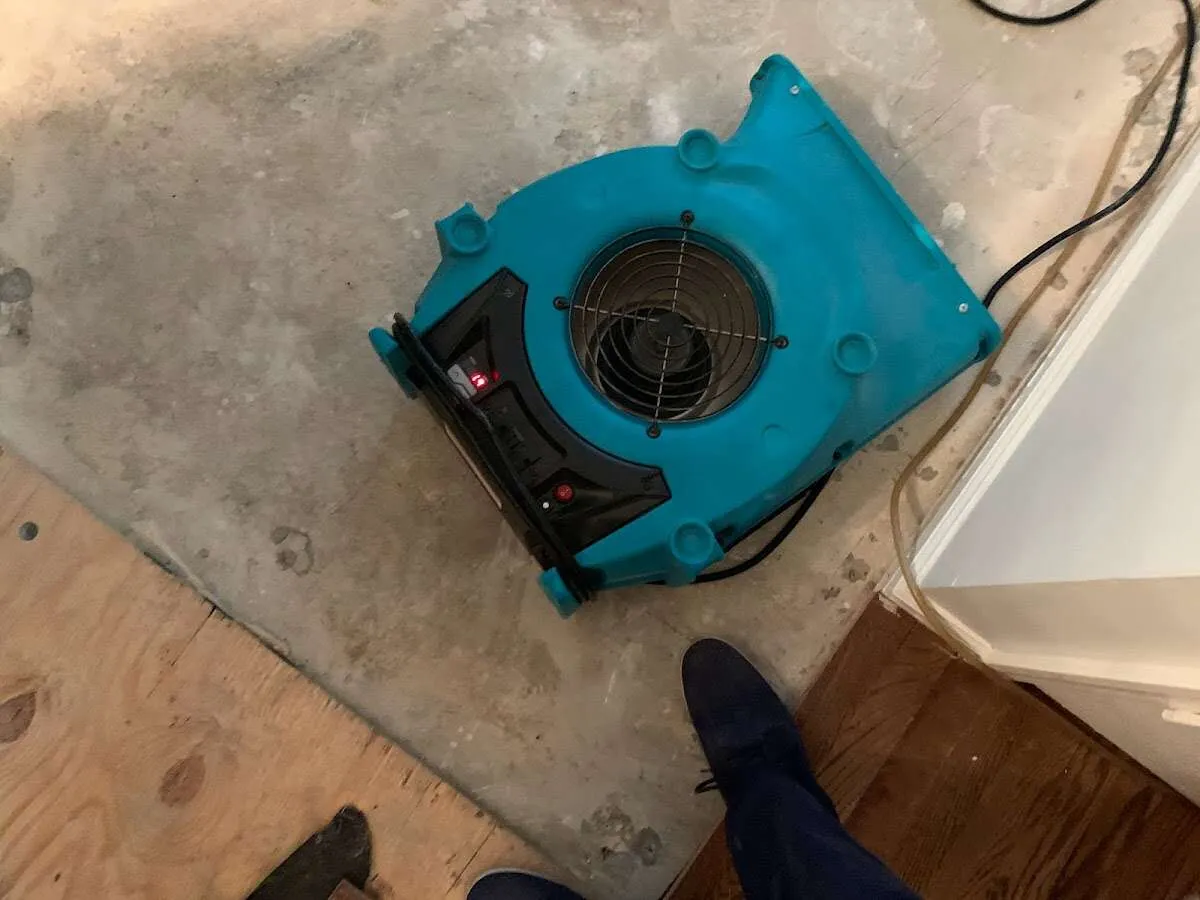 Air mover drying subfloor during Commercial Water Damage Restoration in West Odessa